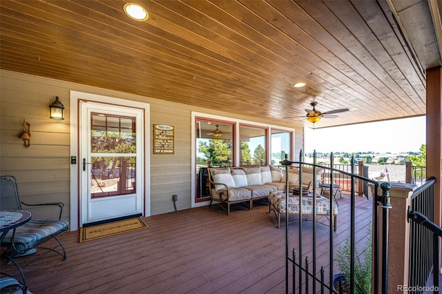 wooden deck featuring an outdoor hangout area and ceiling fan