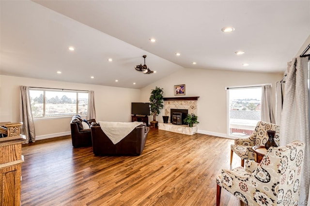 living room featuring lofted ceiling, plenty of natural light, and hardwood / wood-style floors