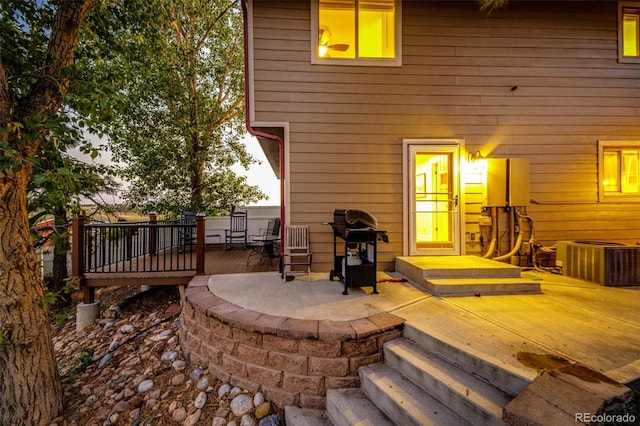 back of property featuring cooling unit, a patio, and a deck