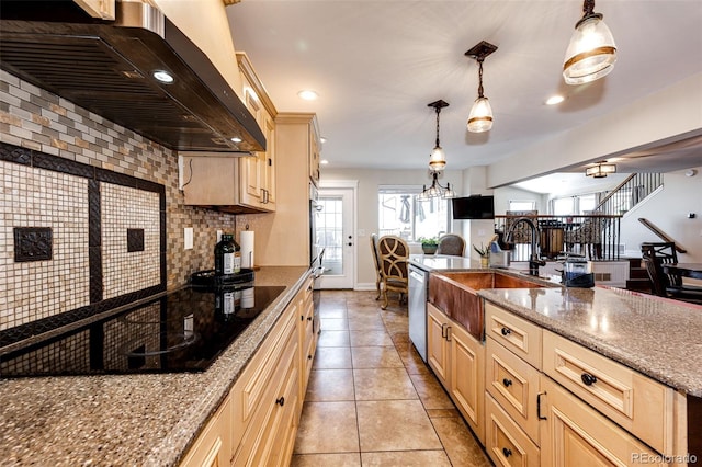 kitchen with exhaust hood, decorative light fixtures, stainless steel dishwasher, light stone countertops, and backsplash