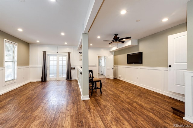 living room featuring dark wood-type flooring and ceiling fan