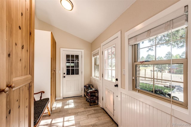 doorway to outside with vaulted ceiling