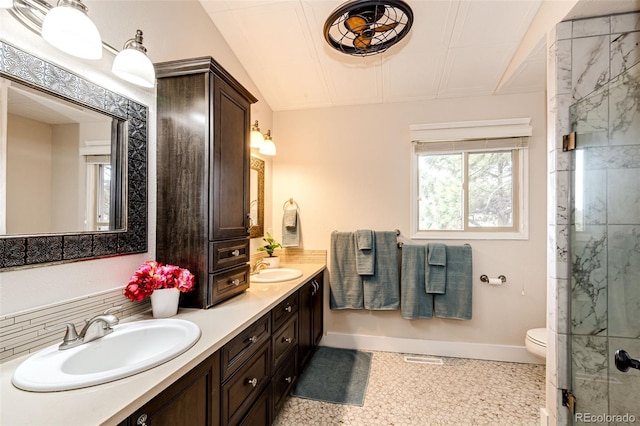 bathroom featuring vanity, toilet, and a shower with shower door