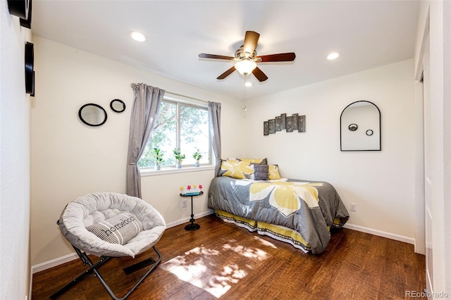 bedroom with dark hardwood / wood-style flooring and ceiling fan