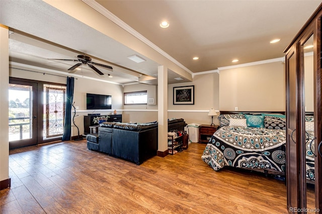 living room with hardwood / wood-style floors, crown molding, french doors, and ceiling fan