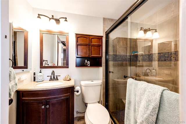 bathroom with vanity, toilet, and walk in shower