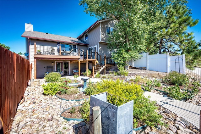 rear view of house featuring a deck