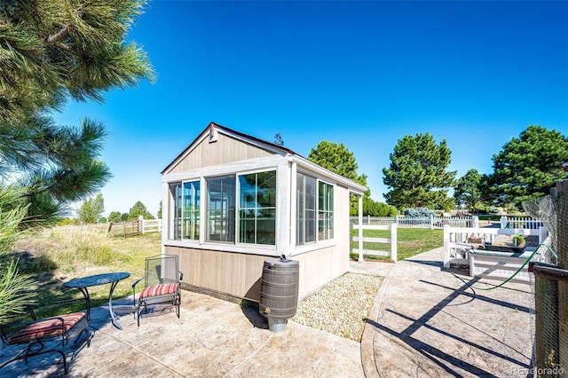 view of side of property featuring a patio