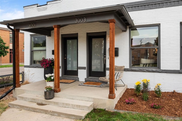 3003 California St, Denver, CO 80205 - doorway to property with a porch and brick siding