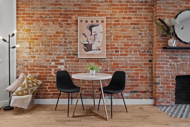 3003 California St, Denver, CO 80205 - dining area with wood finished floors and brick wall