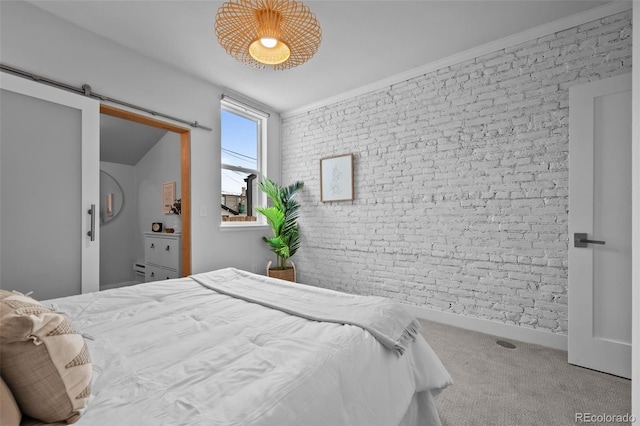 3003 California St, Denver, CO 80205 - bedroom featuring brick wall, a barn door, an accent wall, and carpet floors