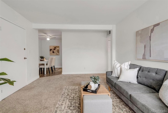 carpeted living room featuring ceiling fan