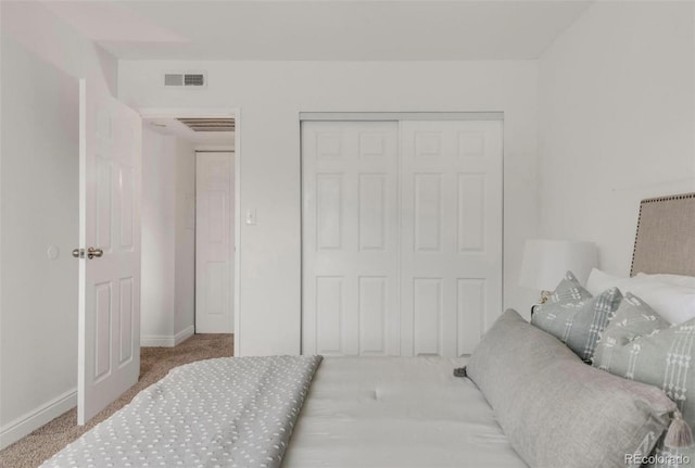 carpeted bedroom featuring a closet