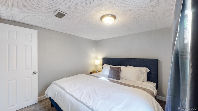 bedroom with dark colored carpet