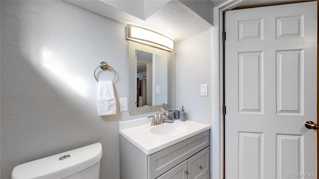 bathroom featuring oversized vanity and toilet