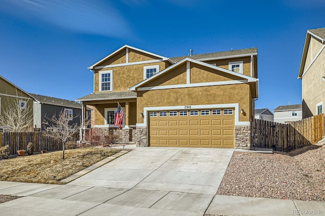 view of front facade with fence, a garage, driveway, and stucco siding