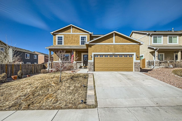 craftsman-style house with fence, driveway, covered porch, stucco siding, and a garage