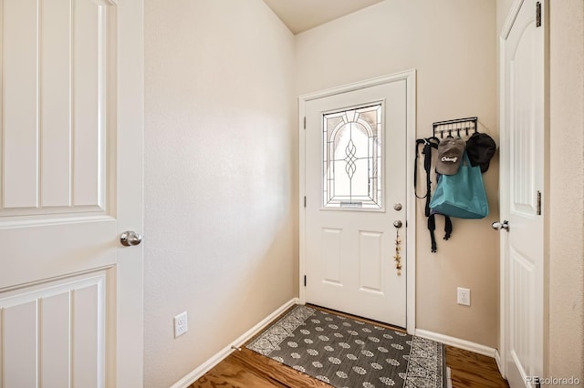 entrance foyer with baseboards and wood finished floors