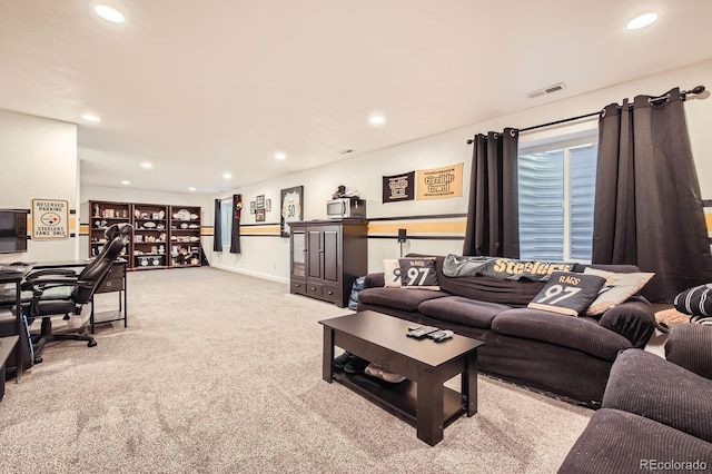 living area with recessed lighting, visible vents, and carpet flooring