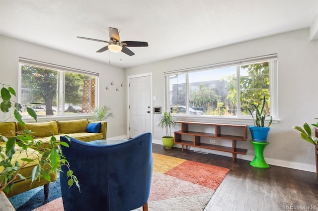 living room with dark hardwood / wood-style floors, plenty of natural light, and ceiling fan