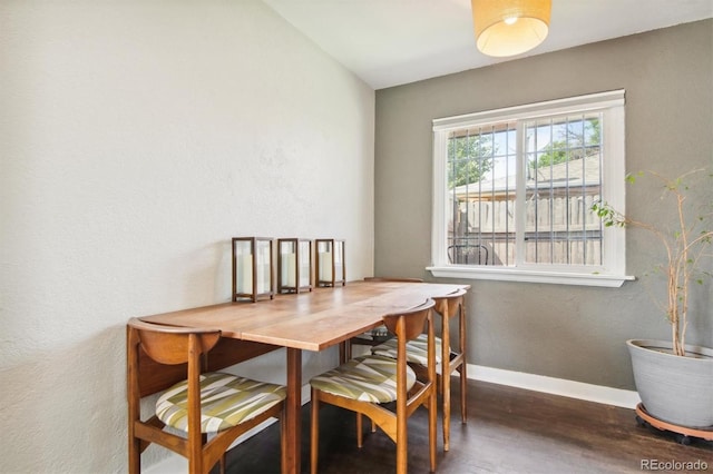 dining space with dark wood-type flooring