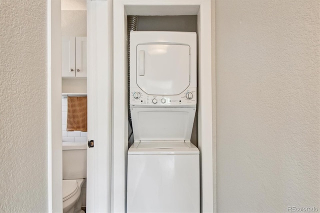 laundry area with stacked washer and clothes dryer