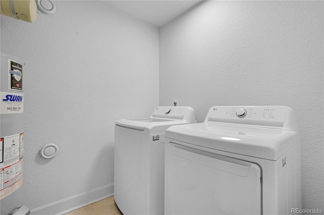 5730 E 19th Ave, Denver, CO 80220 - laundry area featuring washing machine and dryer and light tile patterned floors