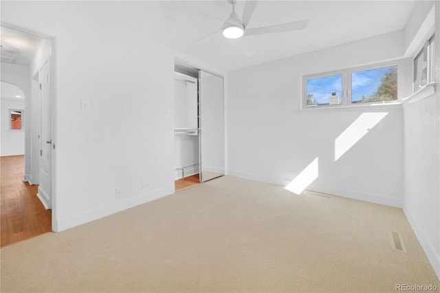 5730 E 19th Ave, Denver, CO 80220 - unfurnished bedroom with carpet floors, arched walkways, baseboards, a closet, and ceiling fan
