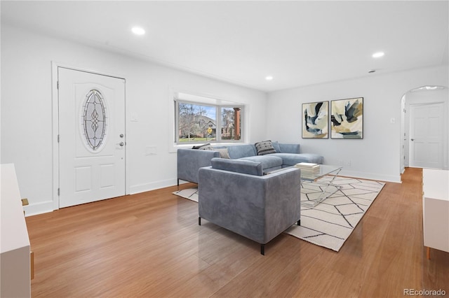5730 E 19th Ave, Denver, CO 80220 - living room featuring arched walkways, light wood-style floors, recessed lighting, and baseboards