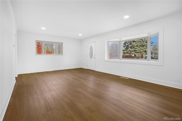 5730 E 19th Ave, Denver, CO 80220 - unfurnished living room with baseboards, dark wood-type flooring, and recessed lighting