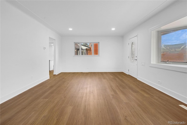 5730 E 19th Ave, Denver, CO 80220 - unfurnished living room featuring wood finished floors, recessed lighting, and baseboards
