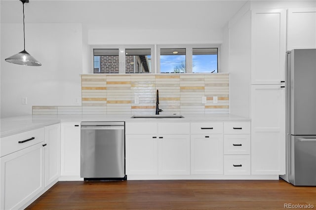5730 E 19th Ave, Denver, CO 80220 - kitchen featuring stainless steel appliances, a sink, backsplash, and white cabinetry