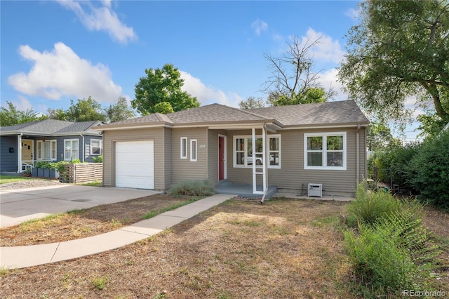 ranch-style house featuring covered porch and a garage