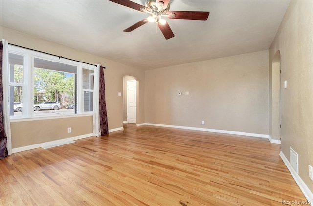 spare room with ceiling fan and light wood-type flooring