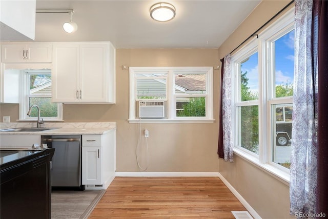 kitchen featuring dishwasher, white cabinets, light hardwood / wood-style flooring, and sink