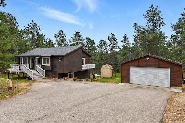 294 Kudu Trl, Bailey, CO 80421 - view of home's exterior with a detached garage, a porch, and view of scattered trees