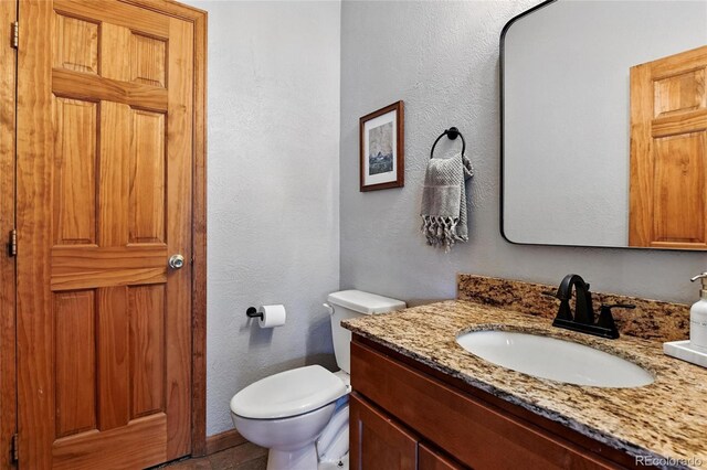 294 Kudu Trl, Bailey, CO 80421 - bathroom with vanity, toilet, and a textured wall