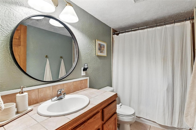 294 Kudu Trl, Bailey, CO 80421 - full bathroom featuring a textured wall, toilet, vanity, a textured ceiling, and tile patterned floors