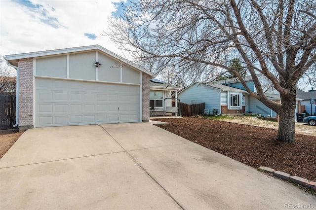 ranch-style home featuring brick siding, an attached garage, and concrete driveway
