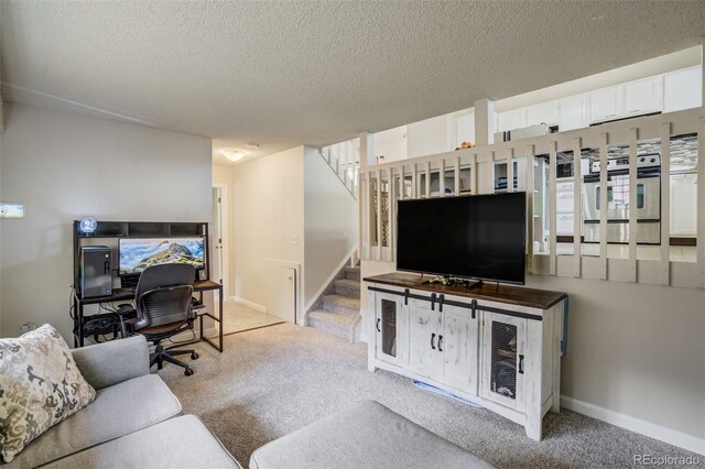 living room featuring a textured ceiling, carpet flooring, baseboards, and stairs