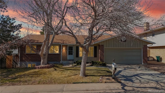 ranch-style house featuring a garage, brick siding, and a front lawn