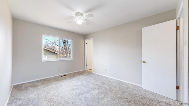 unfurnished room featuring ceiling fan, carpet flooring, visible vents, and baseboards