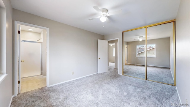 unfurnished bedroom with carpet, baseboards, a closet, and ensuite bathroom