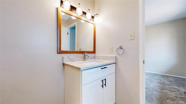 bathroom featuring baseboards and vanity