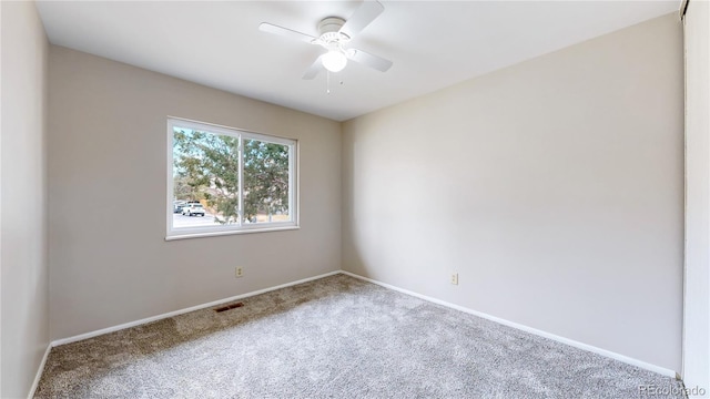 empty room featuring baseboards, visible vents, and carpet flooring