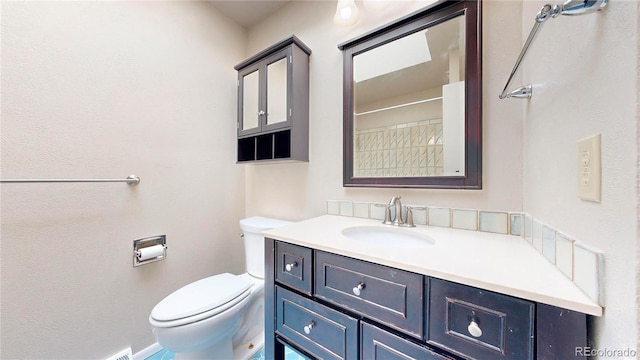 bathroom with toilet and vanity