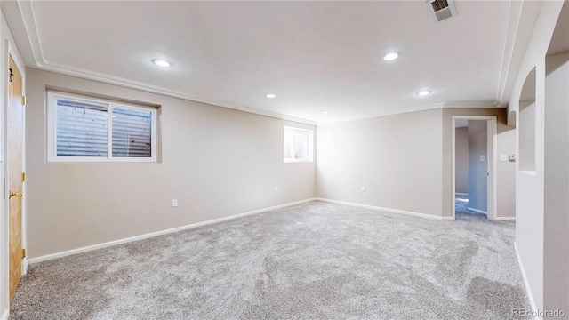 spare room featuring baseboards, visible vents, carpet flooring, and ornamental molding