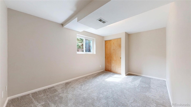 unfurnished bedroom featuring a closet, carpet flooring, visible vents, and baseboards