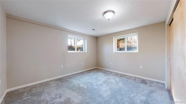 unfurnished bedroom with carpet, visible vents, and baseboards