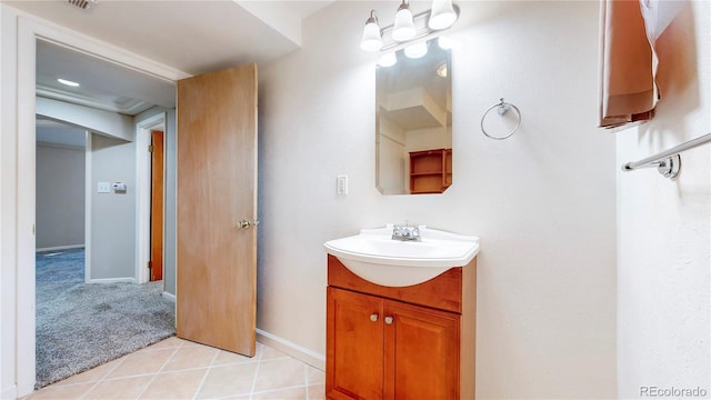 bathroom with tile patterned flooring, baseboards, and vanity